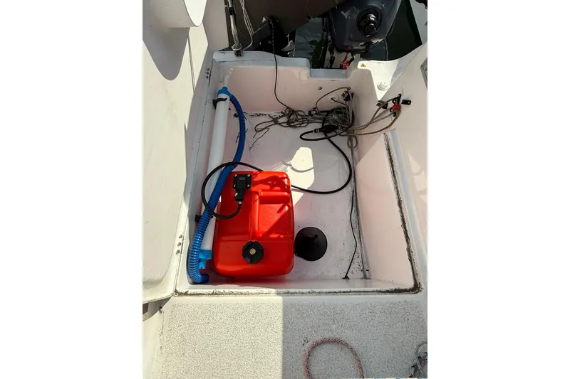 Slide: The Image of Interior of a 2022 Dragonfly 25 boat with red fuel tank and cables. - 31