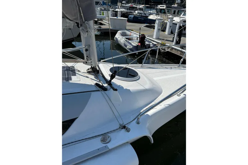 Slide: The Image of Sailboat Dragonfly 25, 2022 model, docked with visible deck and rigging. - 8