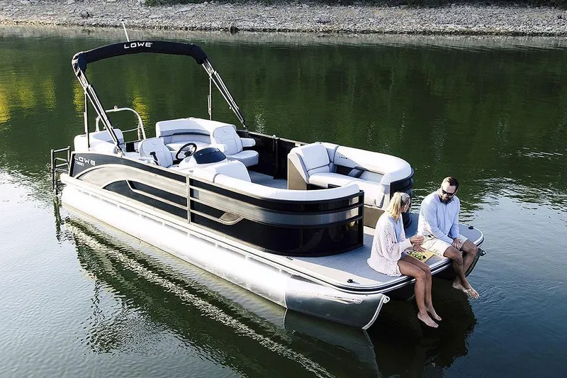 The Image of Manufacturer Provided Image: 2025 Lowe SS 230 WV pontoon boat on calm water with two people relaxing. - 0