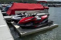 Slide: The Image of 2013 Sea-Doo GTX 215 jet ski docked at marina with red cover nearby. - 2