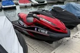 Slide: The Image of Red 2013 Sea-Doo GTX 215 jet ski docked near covered boats. - 3