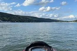 Slide: The Image of 2013 Sea-Doo GTX 215 on a scenic lake with hills and clouds. - 4