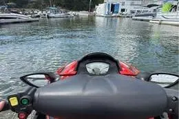 Slide: The Image of 2013 Sea-Doo GTX 215 jet ski on water, marina in background. - 5
