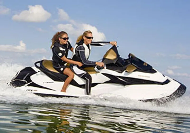 Slide: The Image of Manufacturer Provided Image: 2013 Sea-Doo GTX 215 jet ski with two riders on the water. - 7