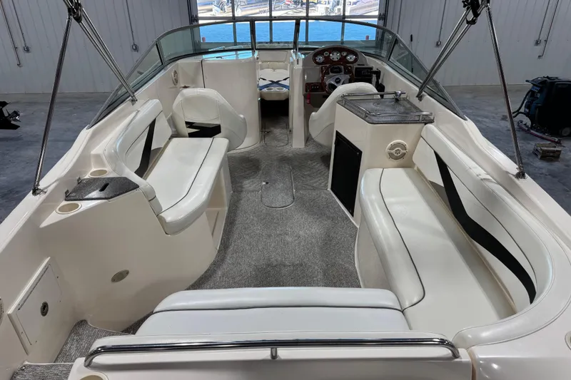 Slide: The Image of 2004 Rinker 282 BR boat interior with seating, steering wheel, and dashboard. - 15