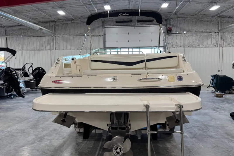 Slide: The Image of 2004 Rinker 282 BR boat in a showroom, rear view with swim platform. - 3