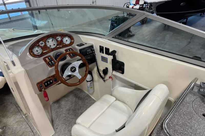 Slide: The Image of 2004 Rinker 282 BR boat cockpit with steering wheel and control panel. - 7