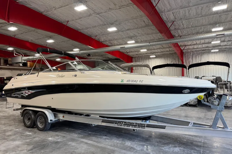 The Image of 2004 Rinker 282 BR boat on trailer in indoor storage facility. - 1