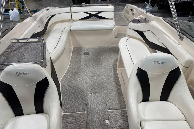 Slide: The Image of 2004 Rinker 282 BR boat interior with white seating and black accents. - 10