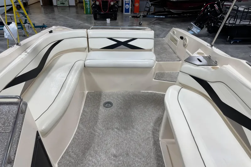 Slide: The Image of 2004 Rinker 282 BR boat interior with white seating and black accents. - 12