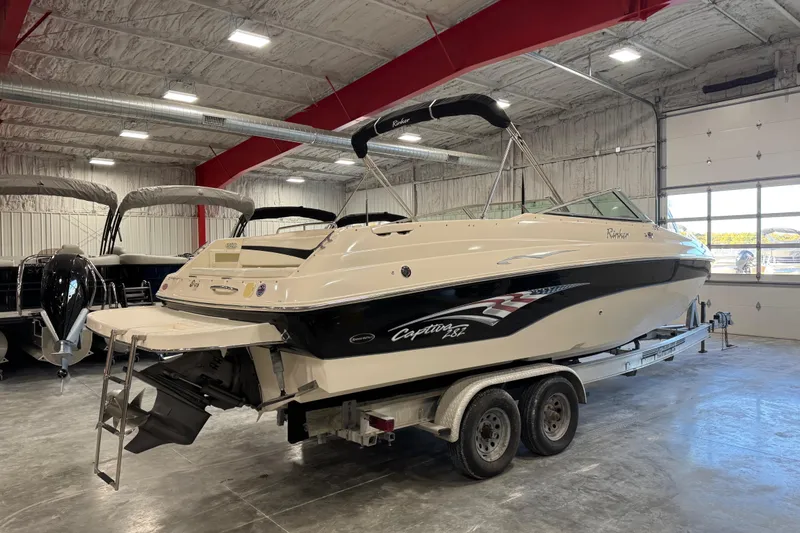 Slide: The Image of 2004 Rinker 282 BR boat on trailer in indoor storage facility. - 4
