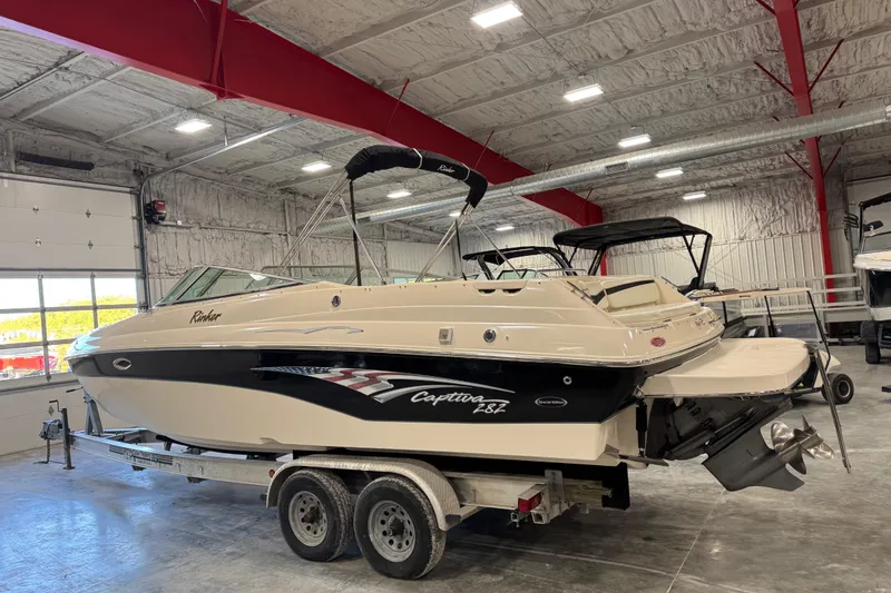Slide: The Image of 2004 Rinker 282 BR boat on trailer in indoor storage facility. - 5