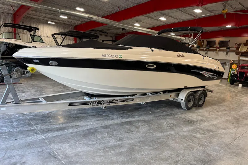 Slide: The Image of 2004 Rinker 282 BR boat on trailer in indoor showroom. - 6
