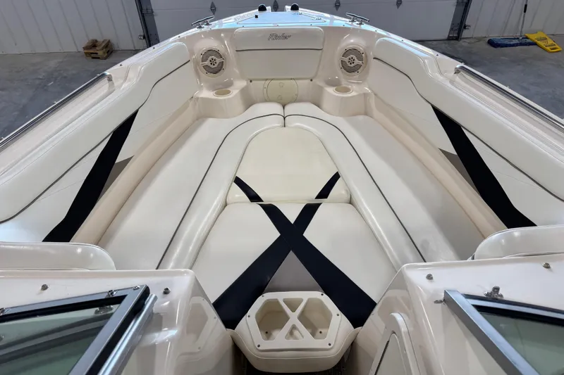 Slide: The Image of 2004 Rinker 282 BR boat interior with white seating and black accents. - 9