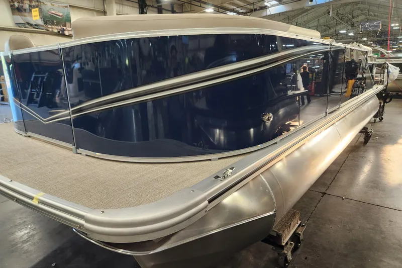 The Image of 2026 Avalon LSZ Quad Lounger pontoon boat in showroom, featuring sleek design and modern finishes. - 0