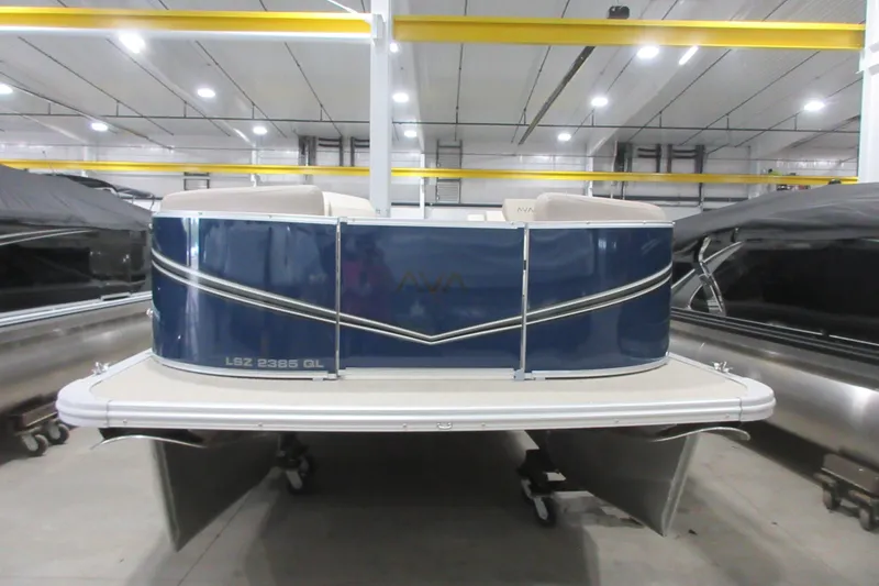 Slide: The Image of 2026 Avalon LSZ Quad Lounger pontoon boat in a showroom setting. - 12