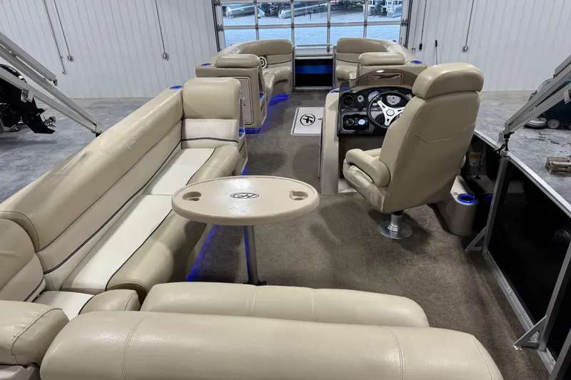 Slide: The Image of Luxurious interior of 2012 Harris Grand Mariner 250 pontoon boat with beige seating and modern dashboard. - 11