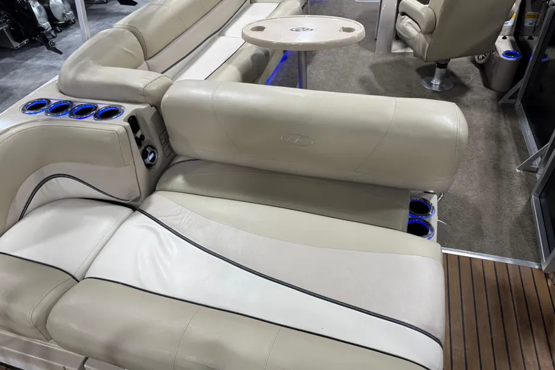 Slide: The Image of Luxurious seating on 2012 Harris Grand Mariner 250 pontoon boat with cup holders and table. - 12