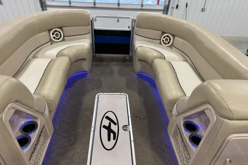 Slide: The Image of 2012 Harris Grand Mariner 250 interior with beige seating and blue LED lighting. - 14