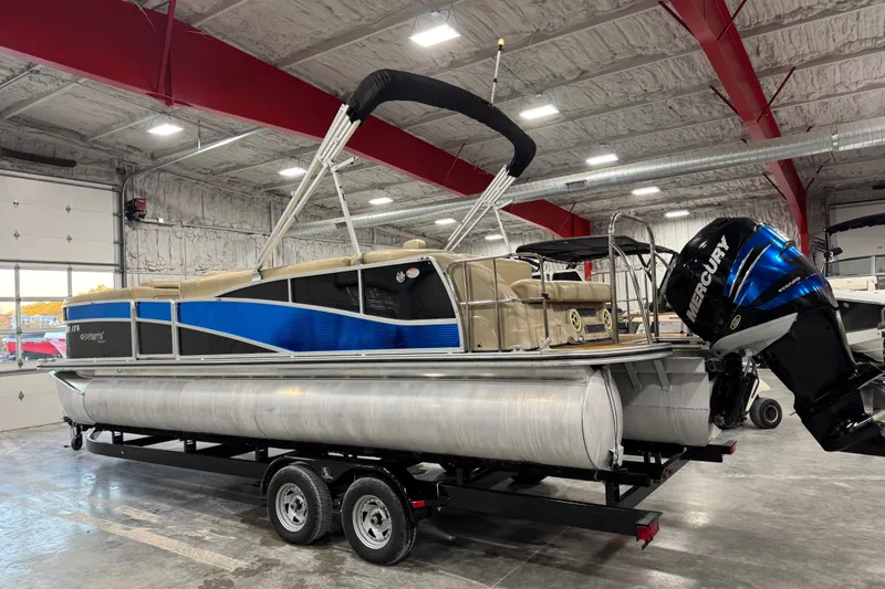Slide: The Image of 2012 Harris Grand Mariner 250 pontoon boat in a showroom, featuring a Mercury outboard motor. - 3