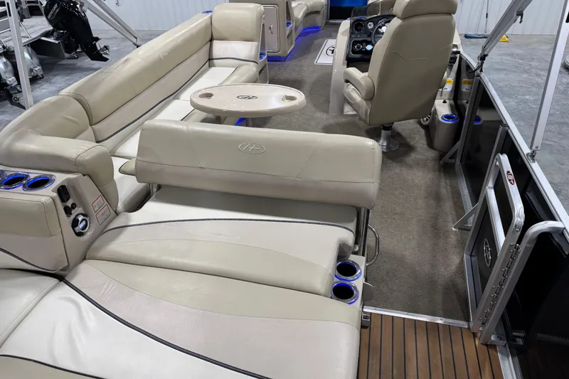Slide: The Image of Interior of 2012 Harris Grand Mariner 250 pontoon boat with beige seating and modern controls. - 8