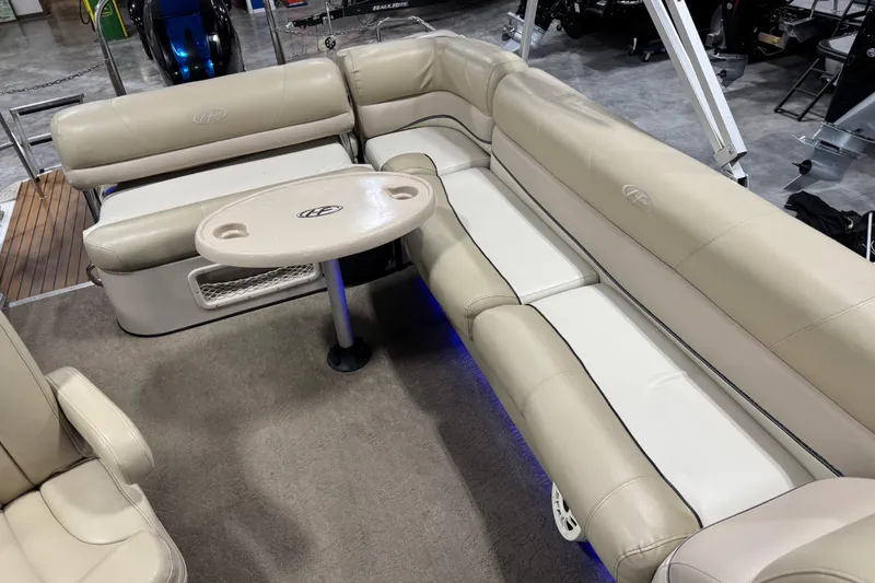 Slide: The Image of 2012 Harris Grand Mariner 250 interior with beige seating and a small table. - 9