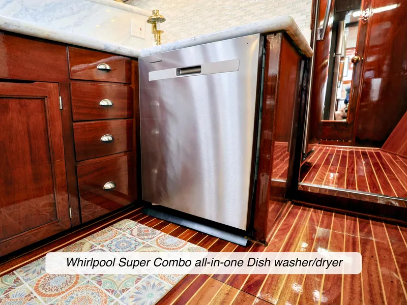 Slide: The Image of 1968 Stephens Motor Yacht kitchen with Whirlpool Super Combo dishwasher, wooden cabinets, and tiled floor. - 11