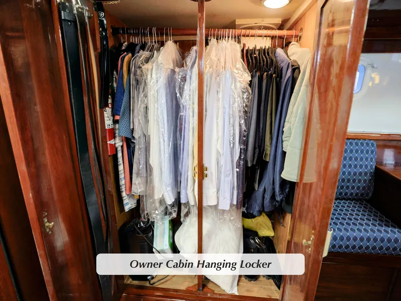 Slide: The Image of Owner cabin hanging locker on 1968 Stephens Motor Yacht, filled with clothes on hangers. - 18