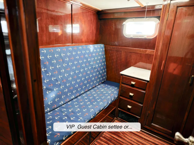 Slide: The Image of 1968 Stephens Motor Yacht VIP guest cabin with anchor-patterned settee and wooden interior. - 23