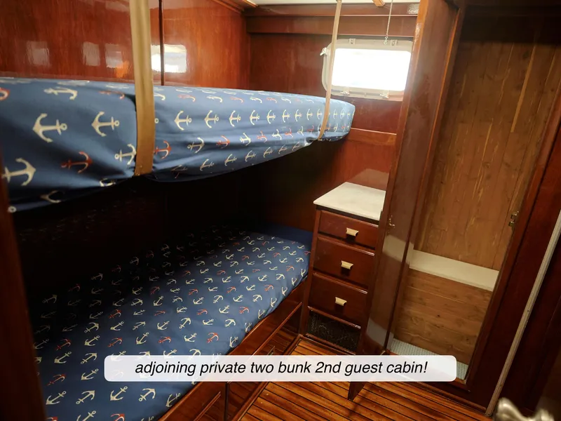 Slide: The Image of 1968 Stephens Motor Yacht guest cabin with two bunk beds and wooden interior. - 24