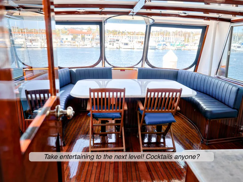 Slide: The Image of Luxurious 1968 Stephens Motor Yacht interior with elegant seating and scenic marina view. - 28
