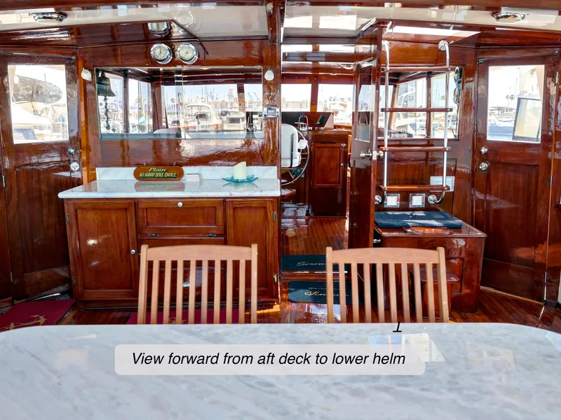 Slide: The Image of 1968 Stephens Motor Yacht interior with wooden finish, view from aft deck to lower helm. - 32
