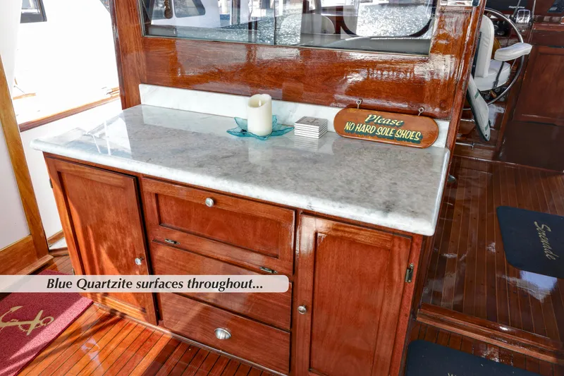 Slide: The Image of 1968 Stephens Motor Yacht interior with blue quartzite surfaces and polished wood cabinetry. - 33