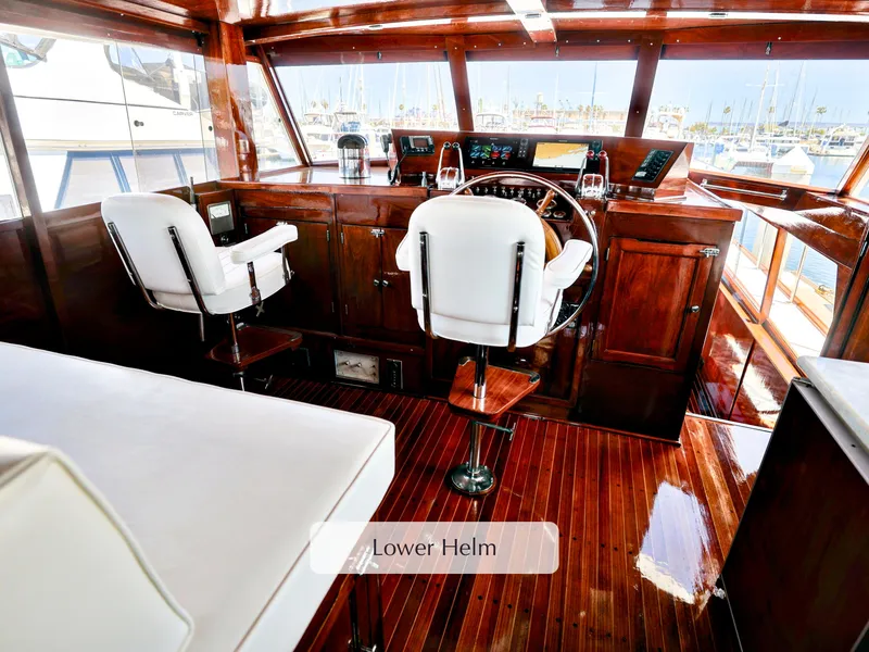 Slide: The Image of Lower helm of 1968 Stephens Motor Yacht with polished wood and white seating. - 35