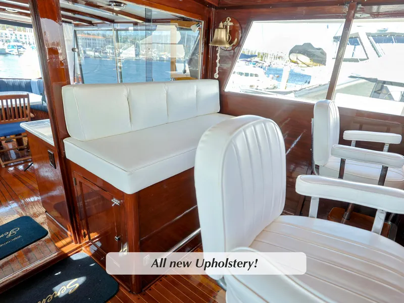 Slide: The Image of 1968 Stephens Motor Yacht interior with new white upholstery and wooden accents. - 37
