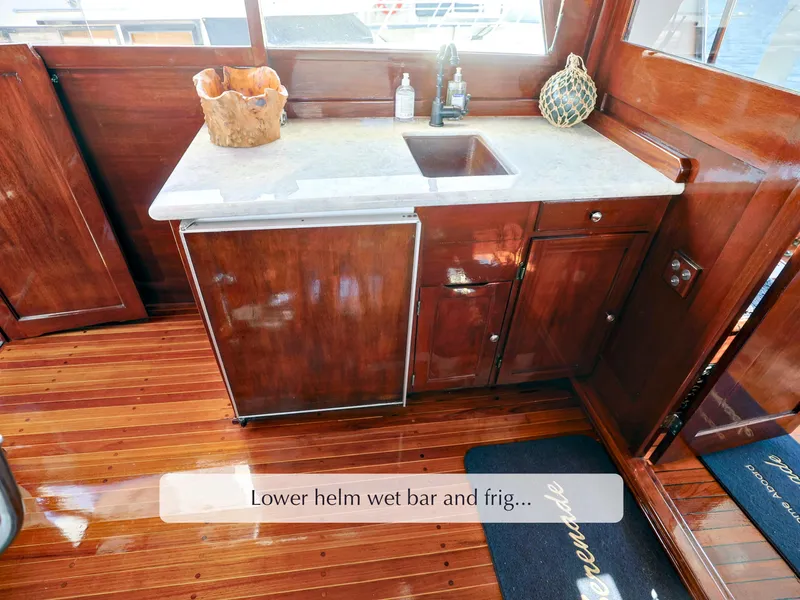 Slide: The Image of Lower helm wet bar with sink and fridge on 1968 Stephens Motor Yacht. - 38