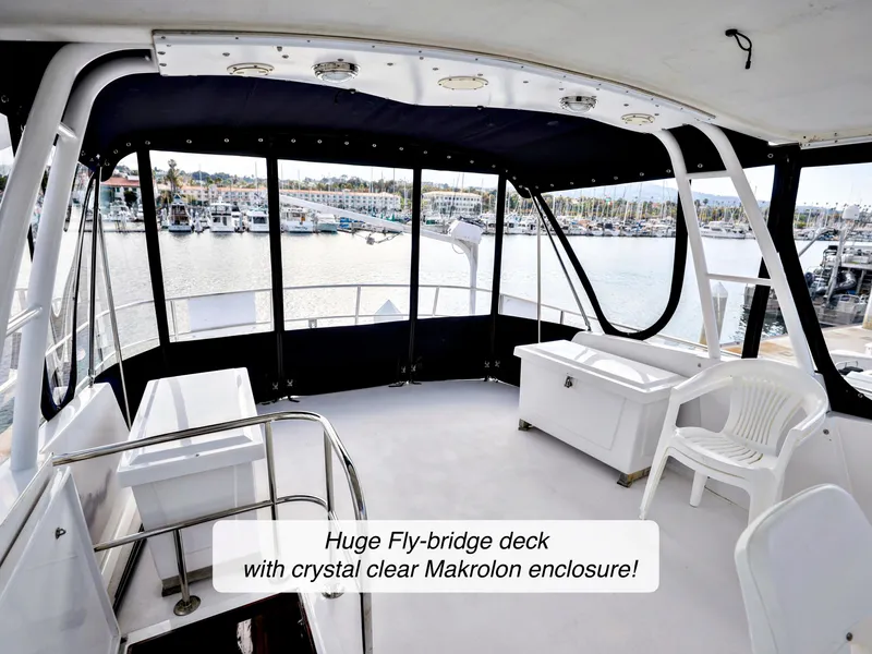 Slide: The Image of 1968 Stephens Motor Yacht fly-bridge deck with clear Makrolon enclosure, overlooking marina. - 44