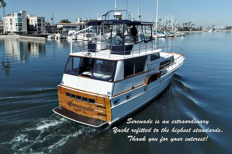 Slide: The Image of 1968 Stephens Motor Yacht cruising in a marina, featuring elegant design and polished wood accents. - 49