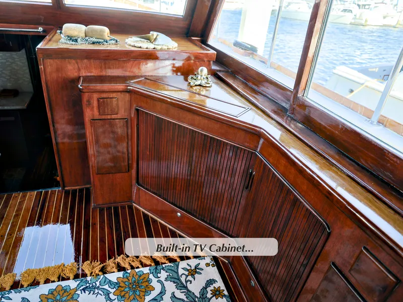 Slide: The Image of Luxurious 1968 Stephens Motor Yacht interior with built-in TV cabinet and polished wood finish. - 5