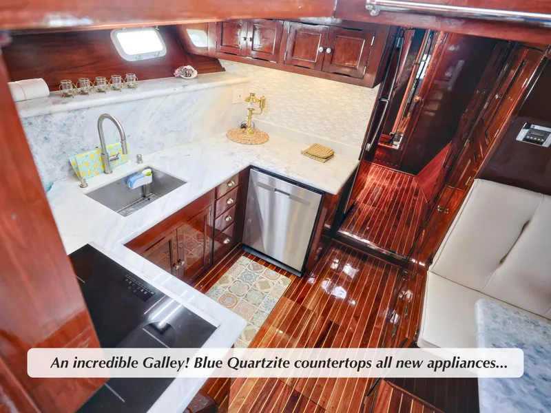 Slide: The Image of Luxurious 1968 Stephens Motor Yacht galley with blue quartzite countertops and modern appliances. - 7