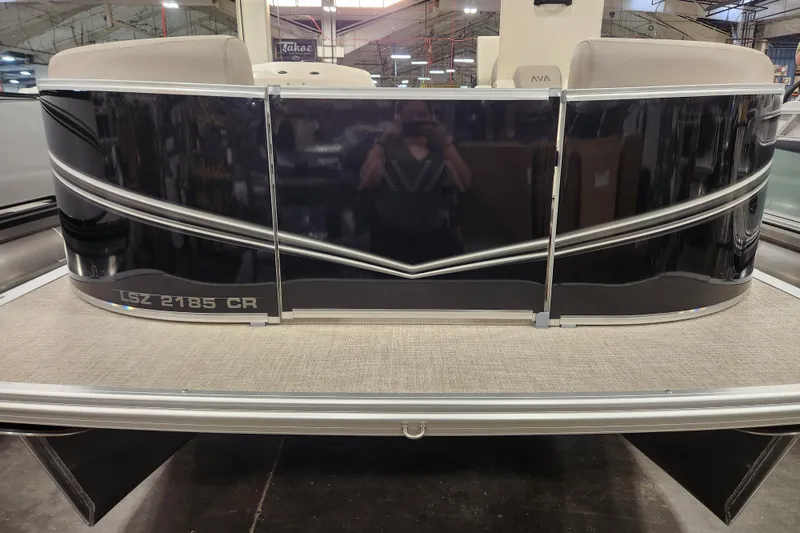 The Image of 2025 Avalon LSZ Cruise pontoon boat, black exterior, displayed indoors. - 0