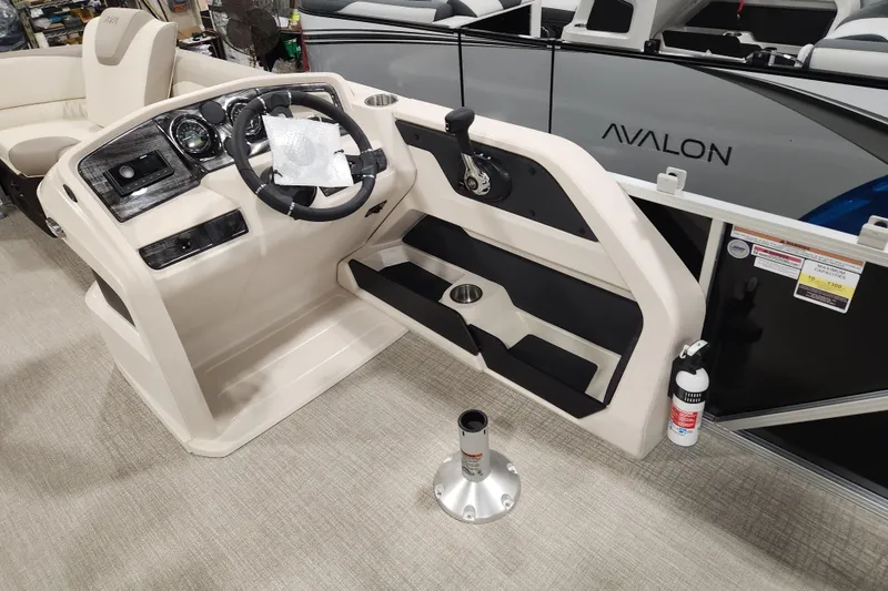 Slide: The Image of 2025 Avalon LSZ Cruise boat interior with steering console and seating area. - 12