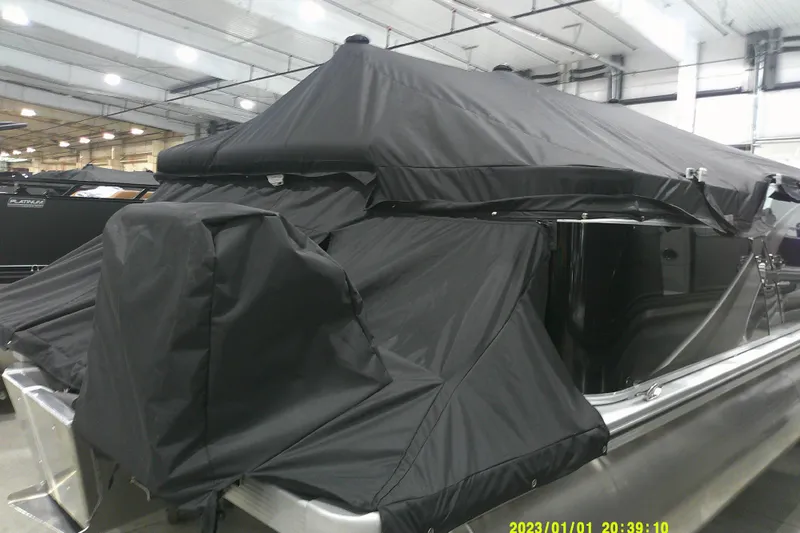 Slide: The Image of 2025 Avalon LSZ Cruise boat with black cover in indoor showroom. - 13