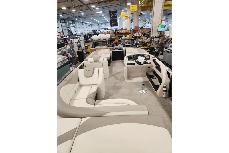 Slide: The Image of 2025 Avalon LSZ Cruise boat interior with luxurious seating and modern dashboard in a showroom. - 6