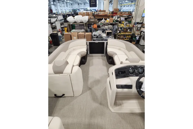 Slide: The Image of 2025 Avalon LSZ Cruise boat interior with beige seating and control panel in a workshop. - 7