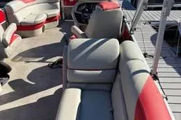 Slide: The Image of 2024 South Bay 2.75 Triple Toon LE pontoon boat with red and gray seating. - 29