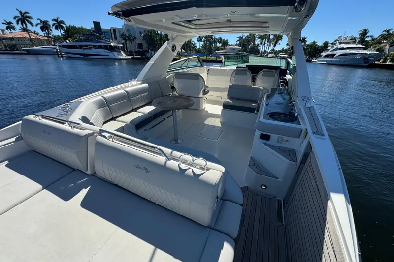 Slide: The Image of 2022 Sea Ray SLX 400 Outboard luxury boat interior with spacious seating and sleek design. - 16