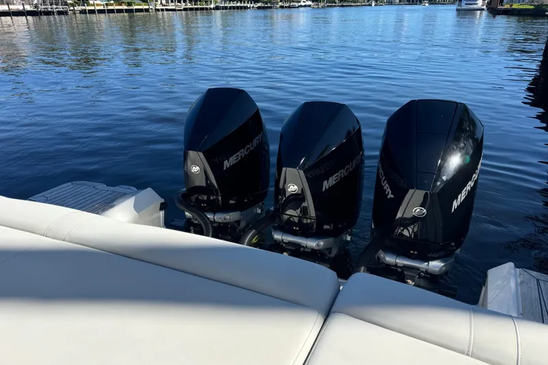 Slide: The Image of 2022 Sea Ray SLX 400 Outboard with triple Mercury engines on calm water. - 23