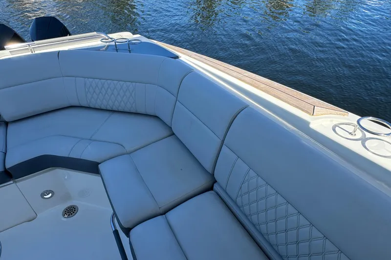 Slide: The Image of Luxurious seating on 2022 Sea Ray SLX 400 Outboard boat, overlooking calm water. - 27