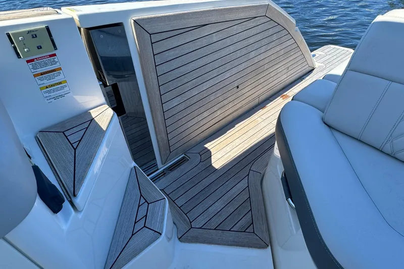 Slide: The Image of 2022 Sea Ray SLX 400 Outboard boat deck with cushioned seating and wood finish. - 29